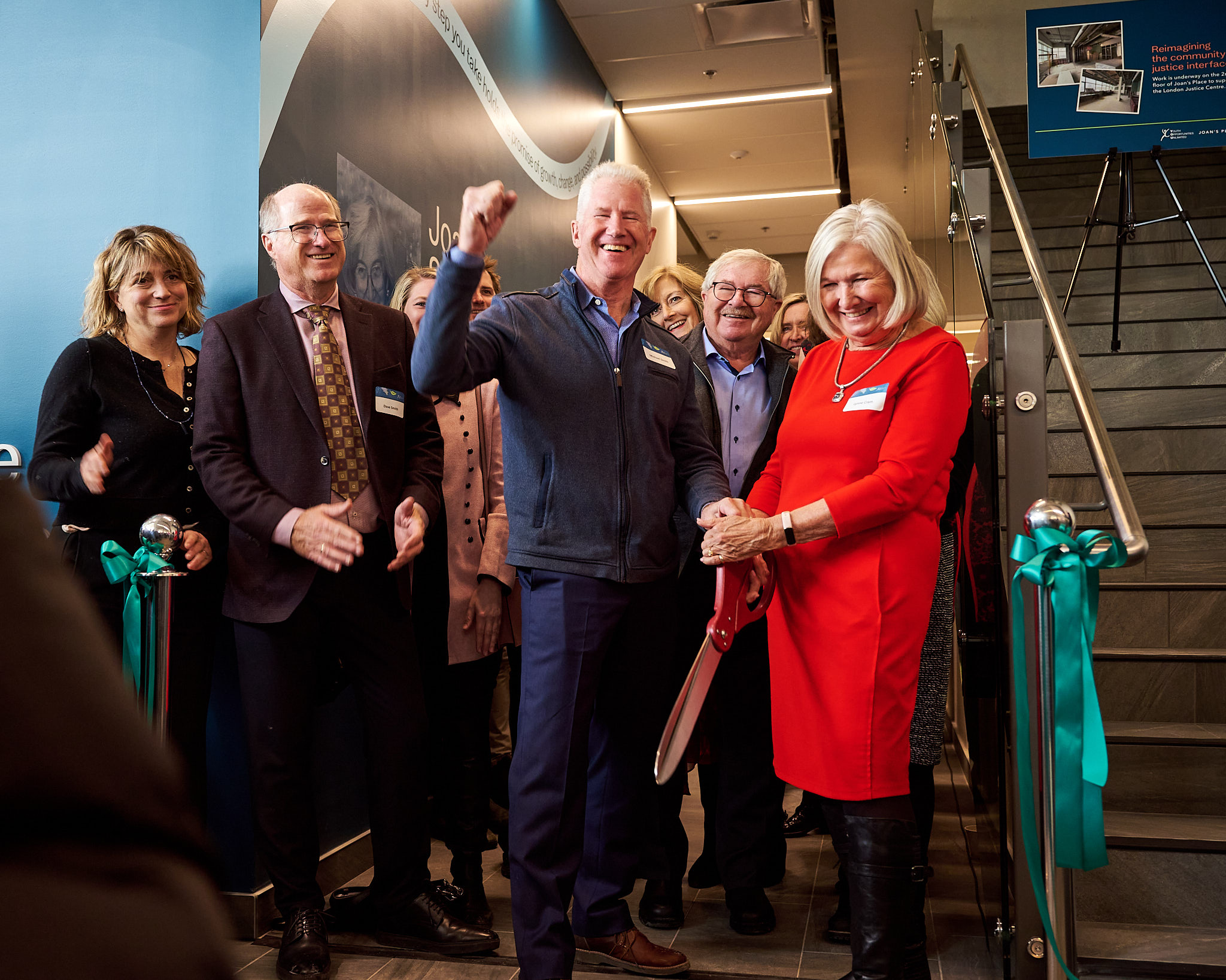 Smith Family cutting the ribbon at the Grand Opening of Joan's Place